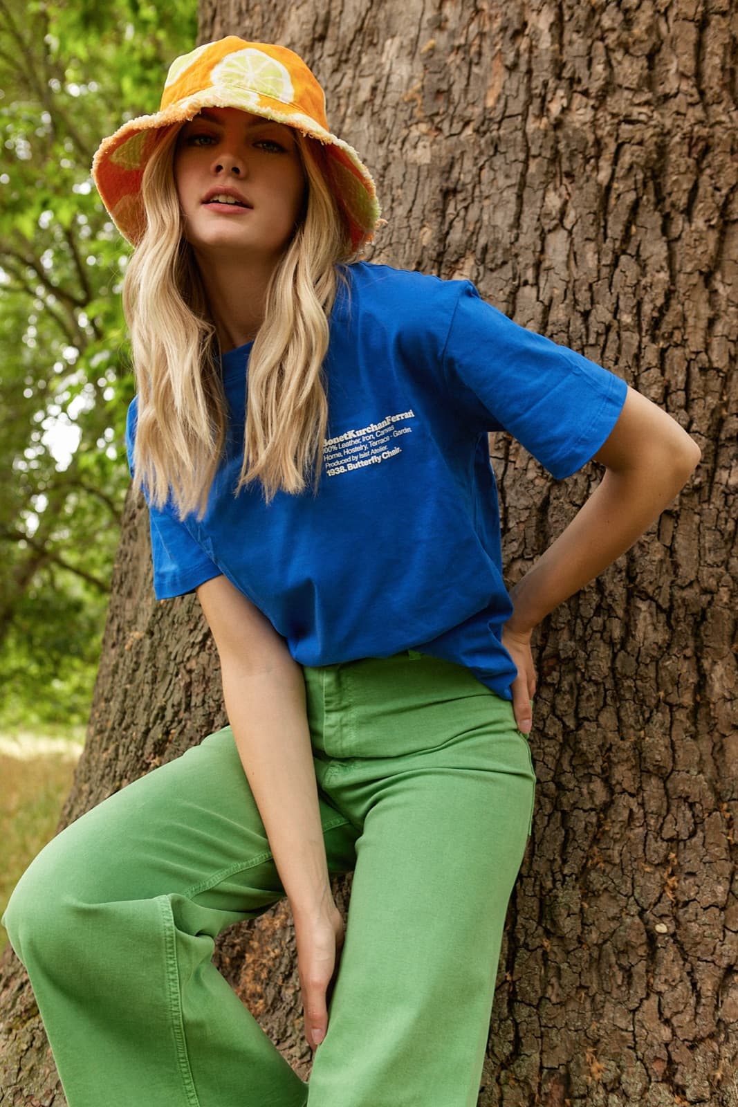 Straight, glossy blonde against a cobalt tee.